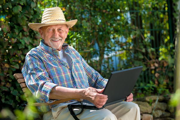 A resident working on a laptop outside